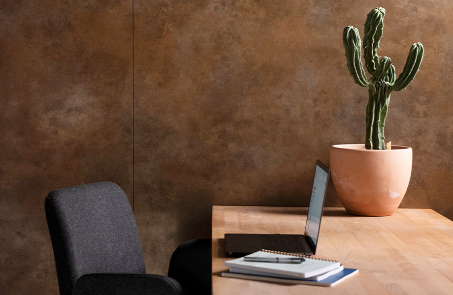 Office wall with M9423 Brass Patina metal panels near desk and cactus